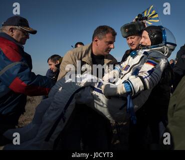 Zhezkazgan, Kazakhstan. 10th Apr, 2017. Russian cosmonaut Sergey Ryzhikov of Roscosmos is helped out of the Soyuz MS-02 spacecraft just minutes after landing in a remote area April 10, 2017 near Zhezkazgan, Kazakhstan. The spacecraft returned carrying the International Space Station Expedition 50 mission crew after 173 days in space. Credit: Planetpix/Alamy Live News Stock Photo