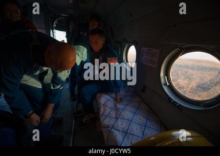 Zhezkazgan, Kazakhstan. 10th Apr, 2017. NASA astronaut Shane Kimbrough, right, rests onboard the MI-8 recover helicopter as he is transported to Karaganda Airport after landing in a remote area April 10, 2017 near Zhezkazgan, Kazakhstan. The spacecraft returned carrying the International Space Station Expedition 50 mission crew after 173 days in space. Credit: Planetpix/Alamy Live News Stock Photo