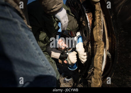 Zhezkazgan, Kazakhstan. 10th Apr, 2017. Russian cosmonaut Sergey Ryzhikov of Roscosmos is helped out of the Soyuz MS-02 spacecraft just minutes after landing in a remote area April 10, 2017 near Zhezkazgan, Kazakhstan. The spacecraft returned carrying the International Space Station Expedition 50 mission crew after 173 days in space. Credit: Planetpix/Alamy Live News Stock Photo