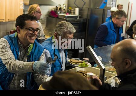 Berlin, Germany. 12th Apr, 2017. The former German Federal President JOACHIM GAUCK and his partner DANIELA SCHADT support the food distribution in the Bahnhofsmission, a Christian charity, at the Berlin Bahnhof Zoo. GAUCK had visited the establishment as Federal President on 14 December 2016 and promised to come back as a helper. The Bahnhofsmission at the zoo provides daily food for up to 600 people, including many homeless and poor people, around the clock. The facility has twelve full-time staff and up to 150 honorary employees. Credit: Jan Scheunert/ZUMA Wire/Alamy Live News Stock Photo