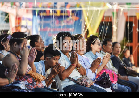 Bangkok, Thailand. 12th Apr, 2017. Worshippers chant Buddhist mantras in the run-up to Songkran at Wat Pho in Bangkok, Thailand, April 12, 2017. In addition to water splashing, people also visit temples and pay tribute to Buddha as a means to celebrate the upcoming Songkran, the traditional Thai New Year which falls on April 13 annually. Credit: Li Mangmang/Xinhua/Alamy Live News Stock Photo