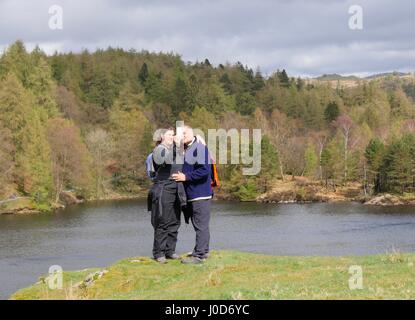 Tarn Hows near Coniston, Cumbria, UK. 12th Apr, 2017. Two people taking a selfie out enjoying a walk around this National Trust natural area of the Lake District on a day of overcast weather with occasional sunshine and showers. © DTNews/Alamy Live Credit: Dan Tucker/Alamy Live News Stock Photo