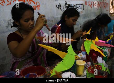 Dhaka, Bangladesh. 12th Apr, 2017. A student of the Art College paints a mask as part of the preparation of the Mangal Shobhajatra festival to celebrate Pahela Baishakh, the first day of the first month of Bangla calendar year 1425, in Dhaka, Bangladesh 12 April 2017. The day will be celebrated on 14 April while the UNESCO added the Mangal Shobhajatra festival on Pahela Baishakh among other new items to the safeguarding intangible cultural heritage list. Stock Photo