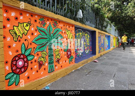 Dhaka, Bangladesh. 12th Apr, 2017. Dhaka 12 April 2017. People walk past colourful wall bengali traditional art on the occasion of Bangla New Year 1424, (Pohela Boishakh) celebration in Institute of Fine Art. Dhaka, Bangladesh. Pohela Boishakh or Bengali New Year is the first day of the Bengali calendar, celebrated on 14 April in Bangladesh. Stock Photo