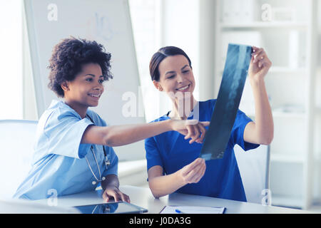 happy female doctors with x-ray image at hospital Stock Photo
