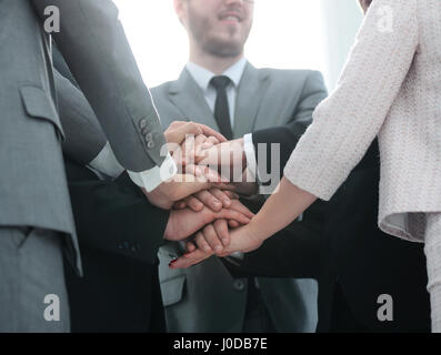 closeup - in the pictures, with the company's employees are standing with folded hands on top of one another. the photo is a blank space for your text Stock Photo