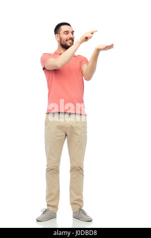 happy man holding something imaginary on hand Stock Photo