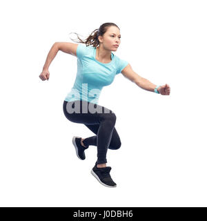 happy sporty young woman jumping in air Stock Photo