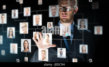 businessman touching screen with contact icons Stock Photo