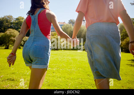 happy teenage couple walking at summer park Stock Photo