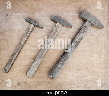 Old steel hammers with wooden handle on the wooden boards background Stock Photo