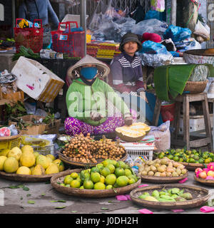 Square portrait of Vietnamese people selling fruit at a market in Vietnam. Stock Photo
