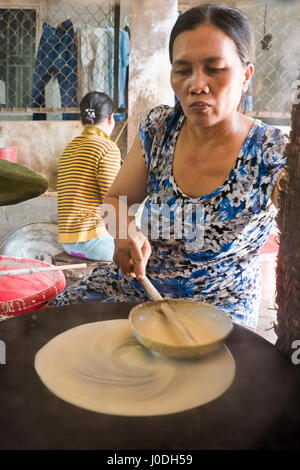 Vertical view of ladies making traditional rice paper in Vietnam. Stock Photo