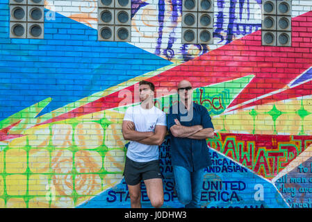 family in front of graffiti covered wall, Pittsburgh, PA. Stock Photo