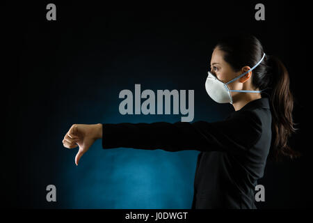 portrait of young business woman wearing a mask. presenting dislike gesture hand. Young multiracial Asian chinese female model Stock Photo