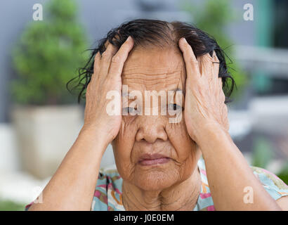 Close up of senior woman with worried stressed face Stock Photo