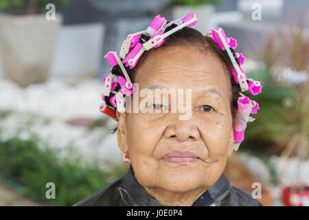 asian senior woman with hair roller Stock Photo