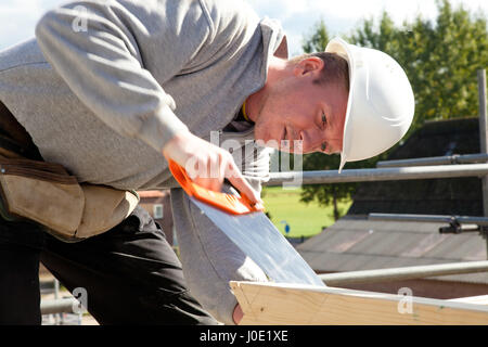 carpenter at work with wooden  construction Stock Photo