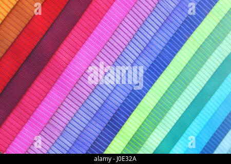 Colored fabric brochure in a diagonal position. Textured background. Stock Photo