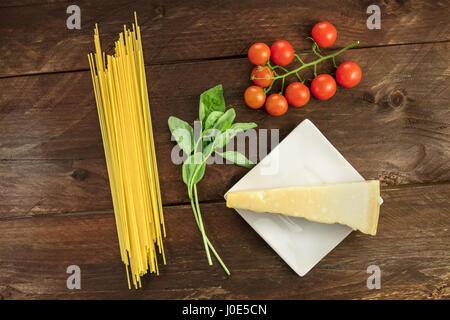 Spaghetti, cherry tomatoes, basil, and cheese, pasta ingredients Stock Photo