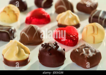 Sweet chocolate pralines on white background Stock Photo