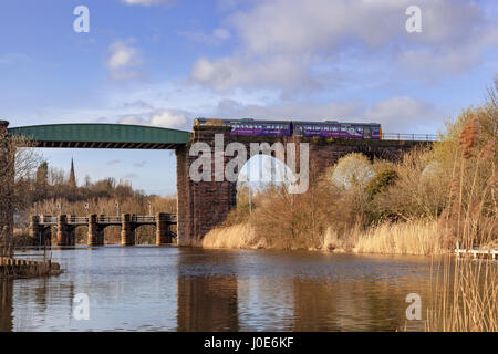 A Northern Rail Pacer diesel passenger train crosses a viaduct over the river Weaver at Northwich. Stock Photo
