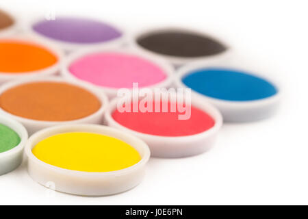 low angle closeup of water color palette in white plastic containers isolated on white selective focus Stock Photo