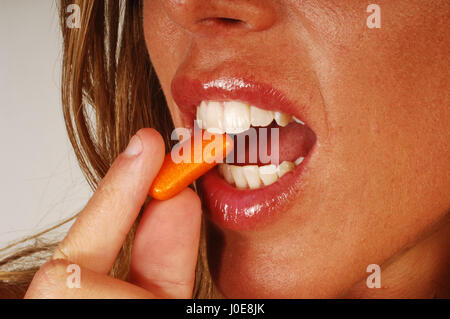 Woman eat with bubble gum on her face Stock Photo