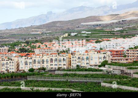 COSTA ADEJE, TENERIFE, CANARY, SPAIN-CIRCA JAN, 2016: Hotels building and banana plantation are on the slope of the mountain in the city of Costa Adej Stock Photo