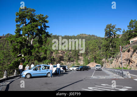 TENERIFE, SPAIN-CIRCA 2016, JAN: Parking area is on the TF-21 road for seeing a thousand-year pine in Vilaflor village. Tourists leave their small car Stock Photo