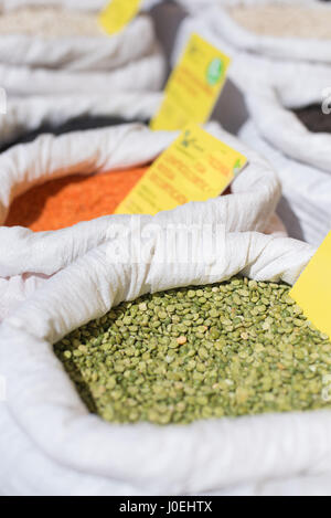 Green dry peas detail in white bag on market shelf selective focus Stock Photo