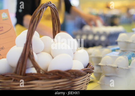 Many white fresh goose eggs in a basket at local open air market Stock Photo