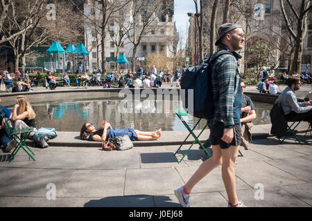 New Yorkers and visitors take advantage of the warm spring weather in Madison Square Park in New York on Monday, April 10, 2017. Temperatures are rising into the 70's, a welcome respite from winter. (© Richard B. Levine) Stock Photo