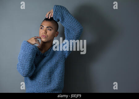 Confident transgender posing while standing over gray background Stock Photo