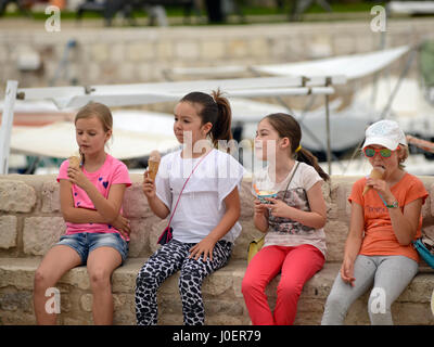 A group of girls eating ice cream during an excursion. Hvar Town, Croatia Stock Photo