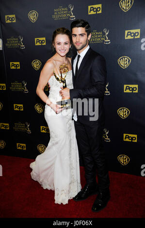 Actress Hunter King (L), winner of the Outstanding Younger Actress in a Drama Series award for 'The Young and the Restless' and actor Max Ehrich pose with an Emmy in the press room at The 42nd Annual Daytime Emmy Awards at Warner Bros. Studios on April 26 Stock Photo