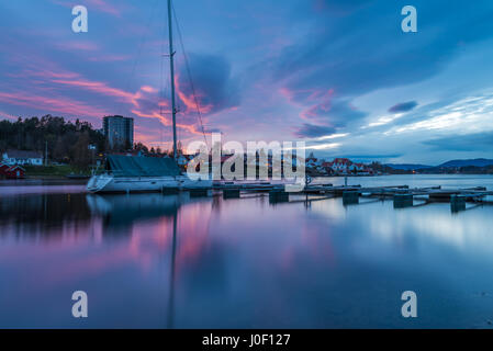 Sunset over dock, harbour and the boats, reflected colorful clouds in the river water 2 - Porsgrunn, Norway Stock Photo