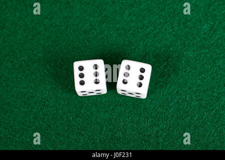 White dices on green table. Stock Photo