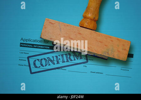 Job application form and wooden stamp on blue background Stock Photo
