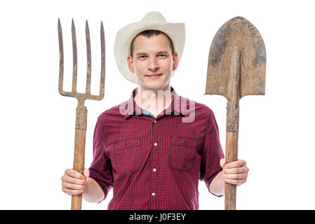 Farmer in hat with pitchforks and shovel on white background Stock Photo