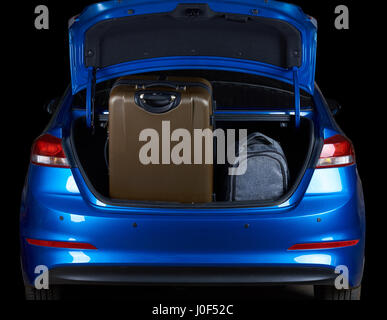 Full loaded car sedan trunk with bags isolated on black background Stock Photo