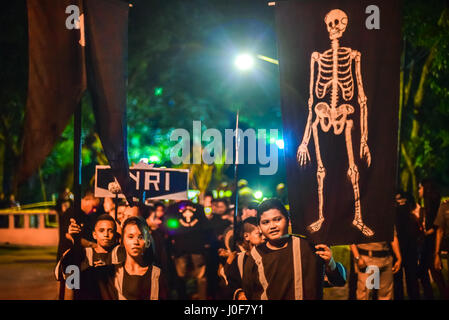 Children bring flags and symbols during Semana Santa procession in Larantuka, Indonesia. Stock Photo