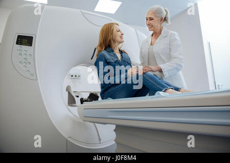 Happy joyful woman looking at her doctor Stock Photo