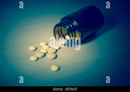 Many type of drugs from the bottle on wooden background. Selective focus/toned photo Stock Photo