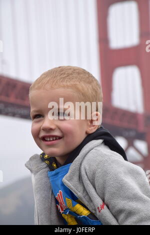 Boy smiling at Golden gate bridge San Francisco Stock Photo