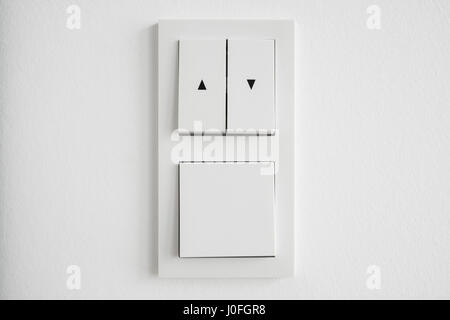 light switch, up down switch closeup on white wall Stock Photo