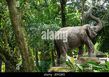 elephant statue made from concrete standing in the middle of green garden photo taken in Ragunan zoo Jakarta Indonesia Stock Photo