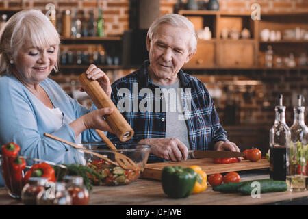 portrait of happy senior couple cooking together at home Stock Photo