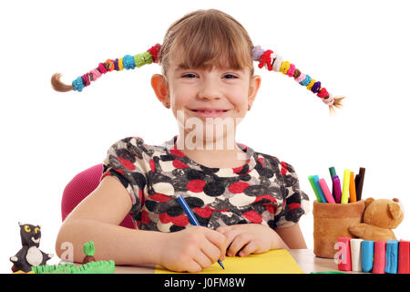 happy little girl with pigtails drawing Stock Photo