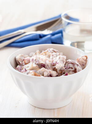 Potato salad made with  boiled baby potatoes, mayonnaise, mustard and chopped red onion. American-style potato salad Stock Photo